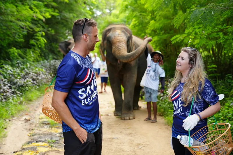 Happy family photo during elephant feeding experience in Phuket
